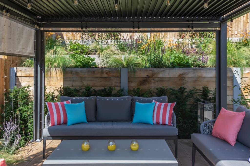 Outdoor living area with furniture and motorized screens for a more comfortable space