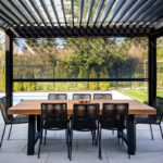 Louvered pergola with Motorized Screen Porch Shades creating a more comfortable covered space
