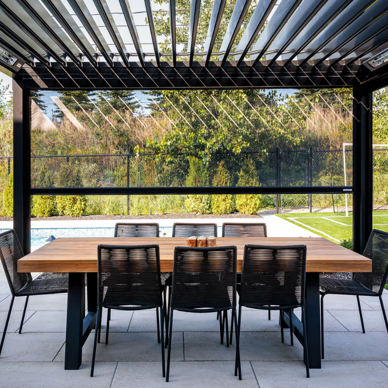 Louvered pergola with Motorized Screen Porch Shades creating a more comfortable covered space