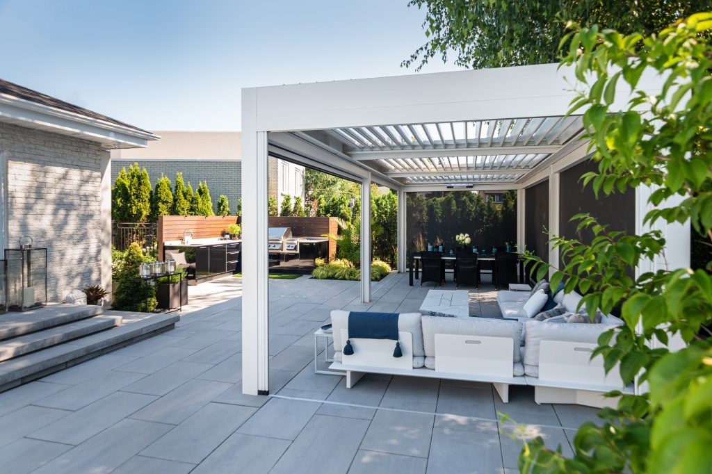 Screened porch with comfortable outdoor seating and natural light