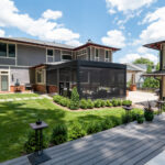 Screened porch connected to a home with views of the surrounding yard