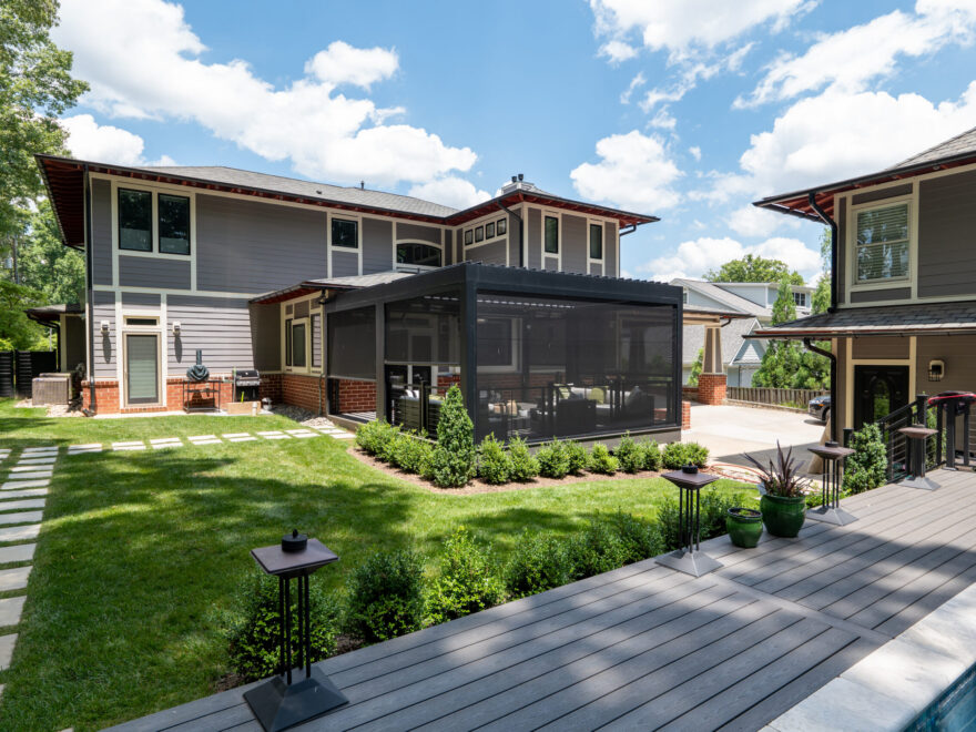 Screened porch connected to a home with views of the surrounding yard