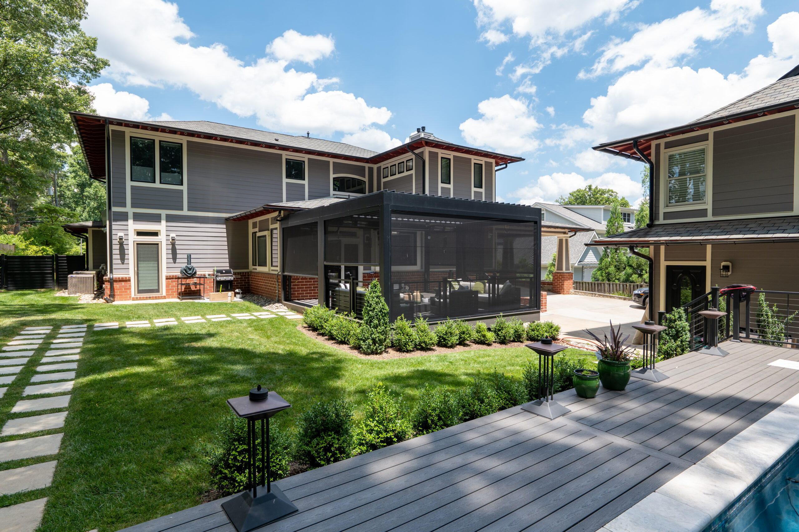 Screened porch connected to a home with views of the surrounding yard